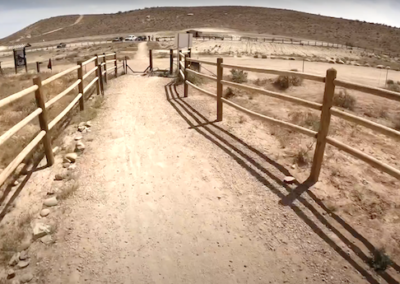 E-Bike Adventure on Bear Claw Poppy Trail: Approaching Trail's End with Wood Fence and White Hills