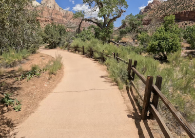 Family E-Bike Adventure on Scenic Pa'Rus Trail: Rustic Fence and Red Rock Views.